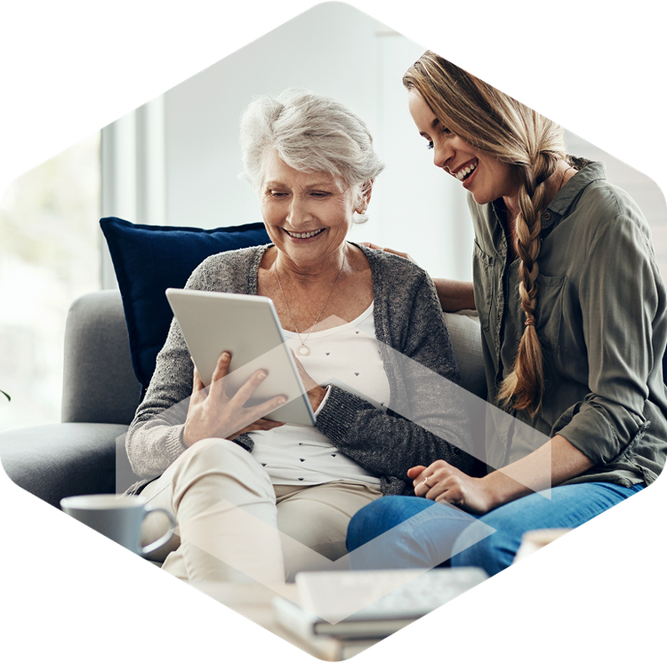 Caregiver and resident looking at a tablet together