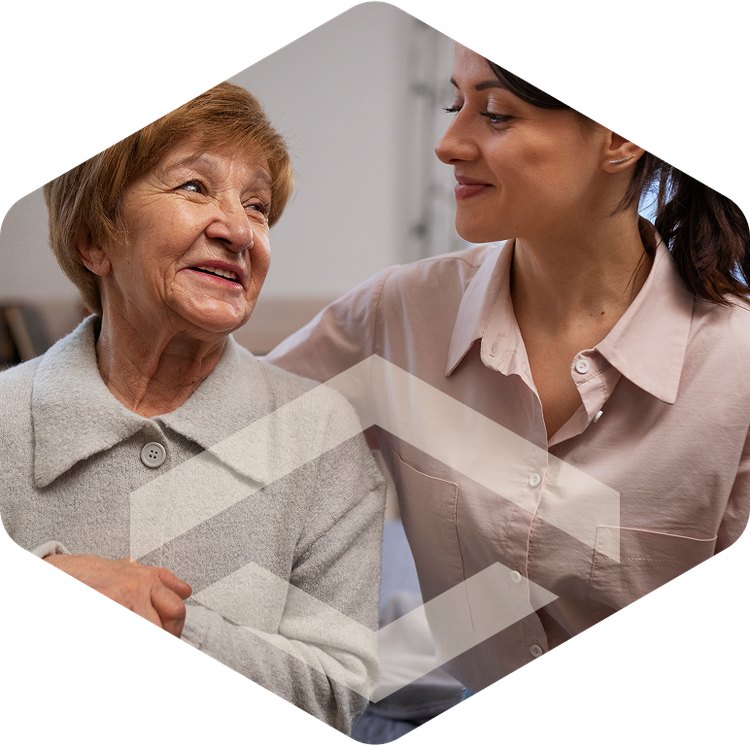 Nurse and elderly resident smiling together