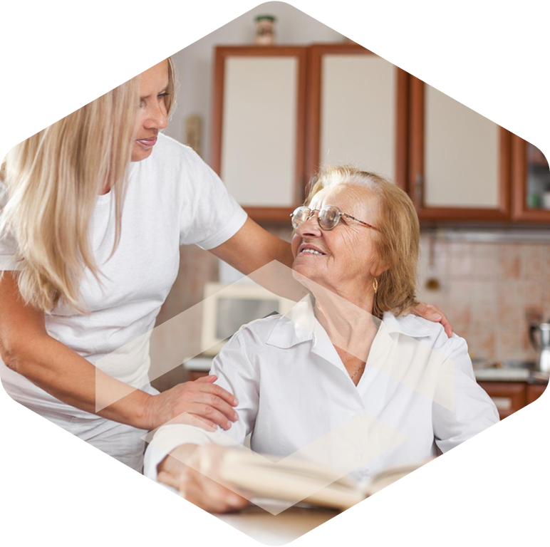 Caregiver smiling with an elderly resident